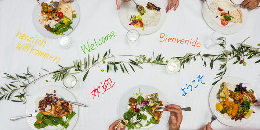 A group of people sitting at a table with plates of food