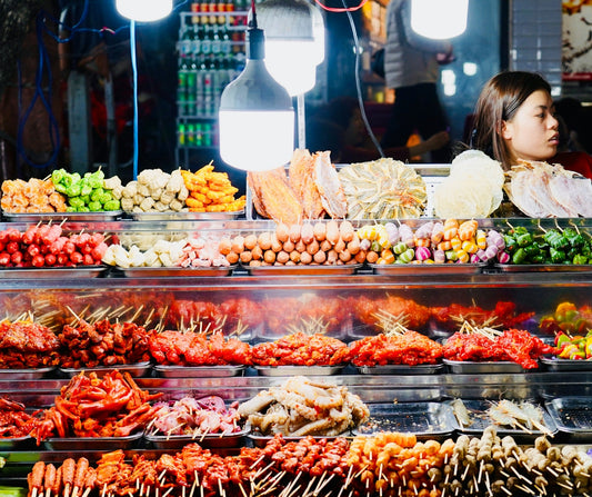Street food stall with various skewers and ingredients
